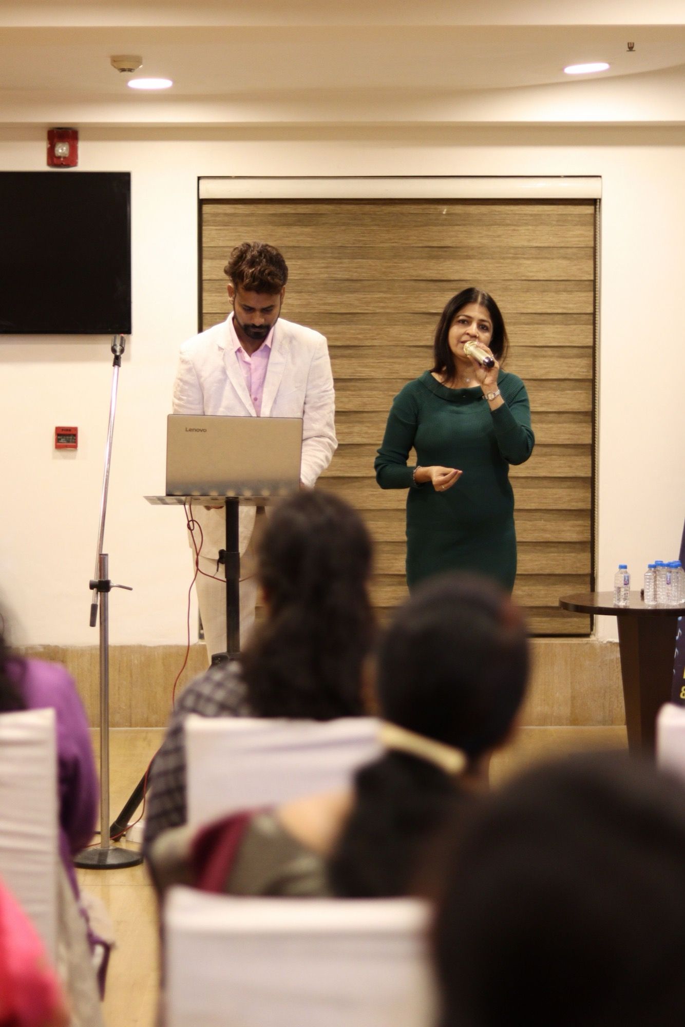 Speaker and host at a conference