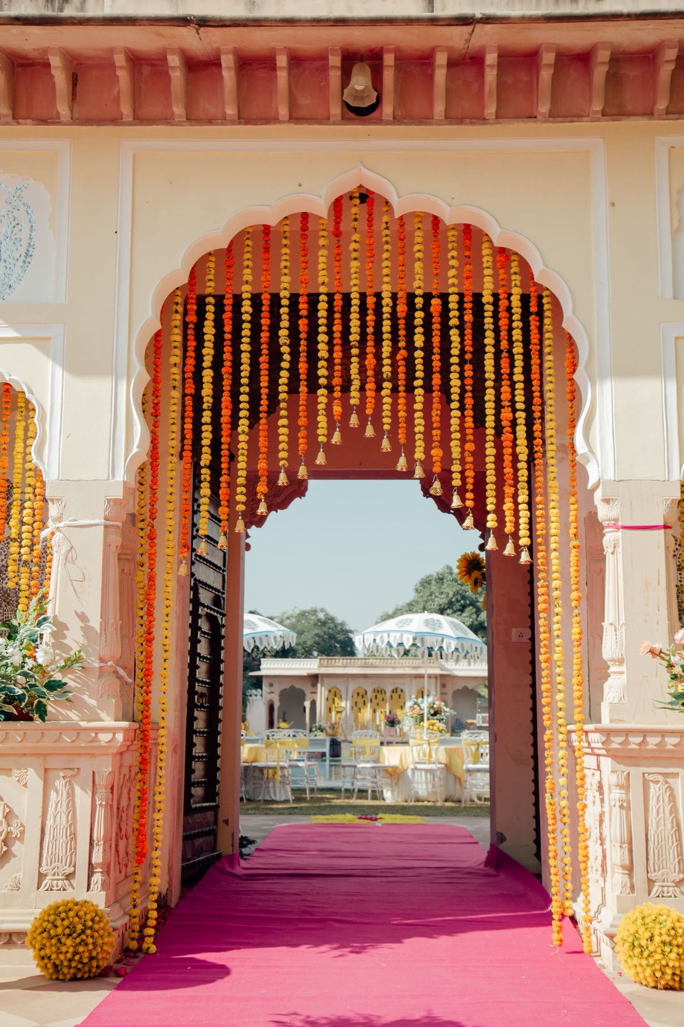 A venue entrance framed in marigold garlands